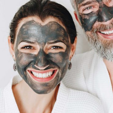 happy-couple-wearing-a-charcoal-mask-AXYBWQ9-scaled.jpg